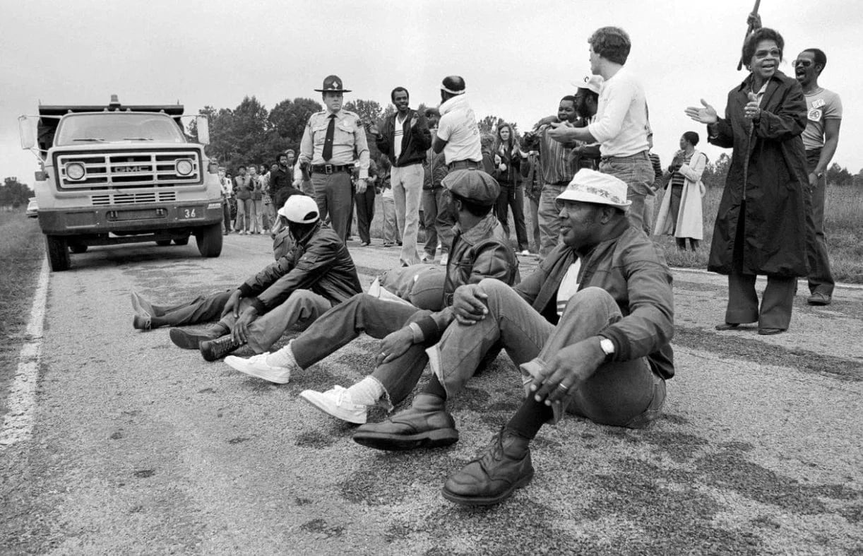 peaceful protestors sitting in road