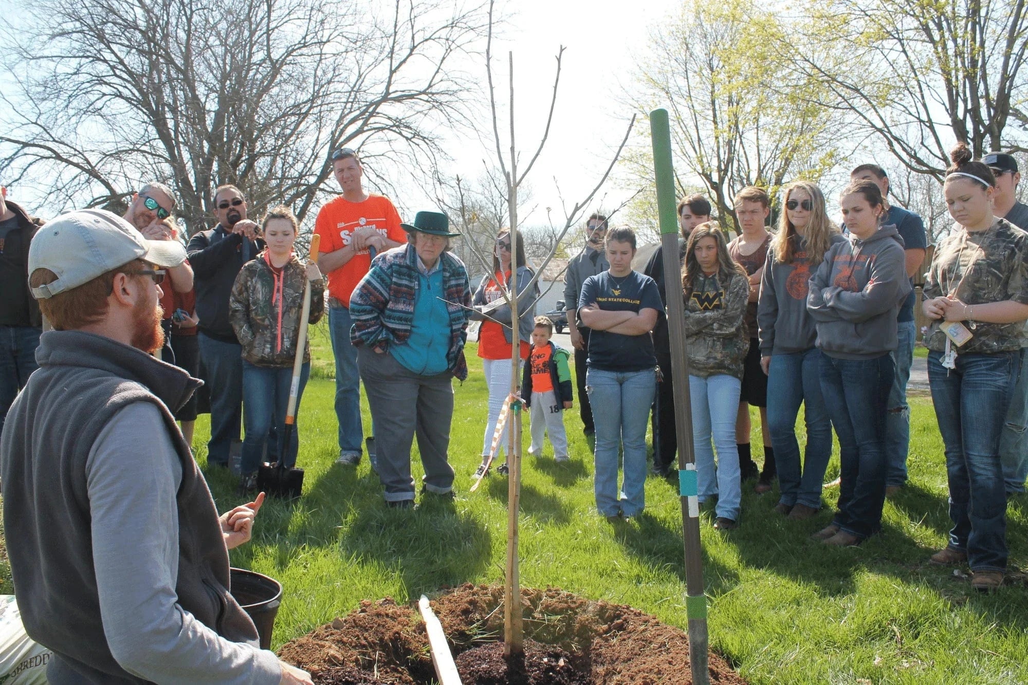tanner haid in front of trees teaching how to plant trees