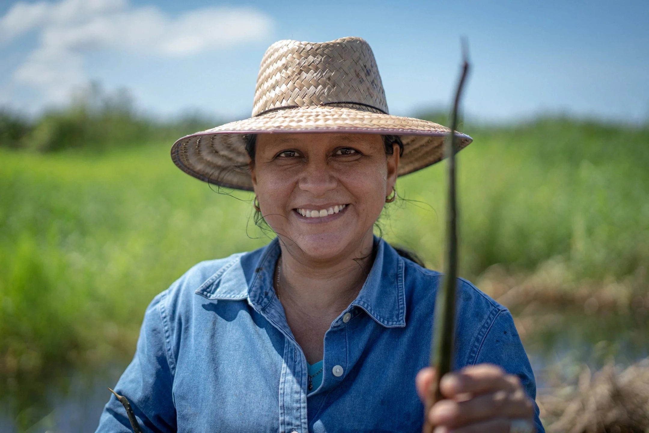 woman holding mangrove seedling