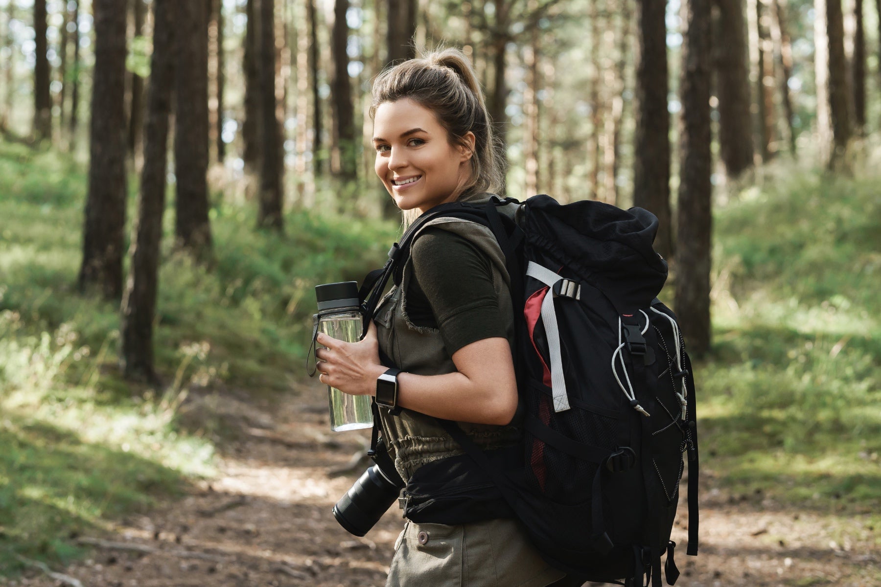 woman hiking reusable water bottle