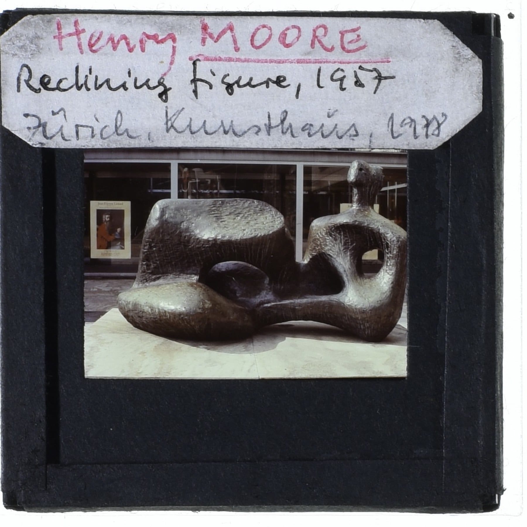 Bronze sculpture titled 'Reclining Figure' by Henry Moore with a label indicating the year 1927.