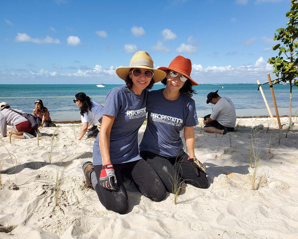 Volunteers wearing Reforestation T-shirt while planting trees