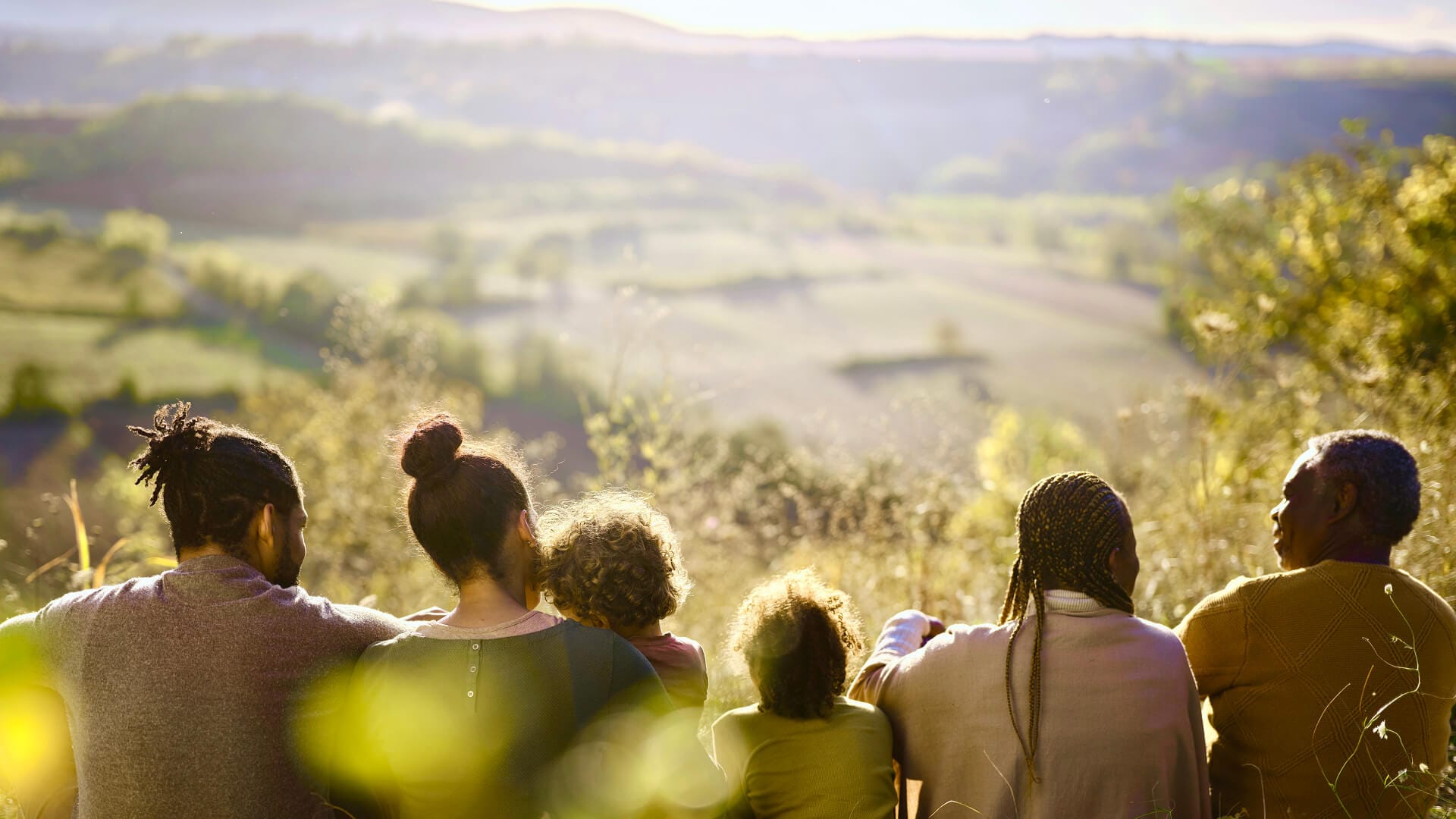 Family watching sunset in forest