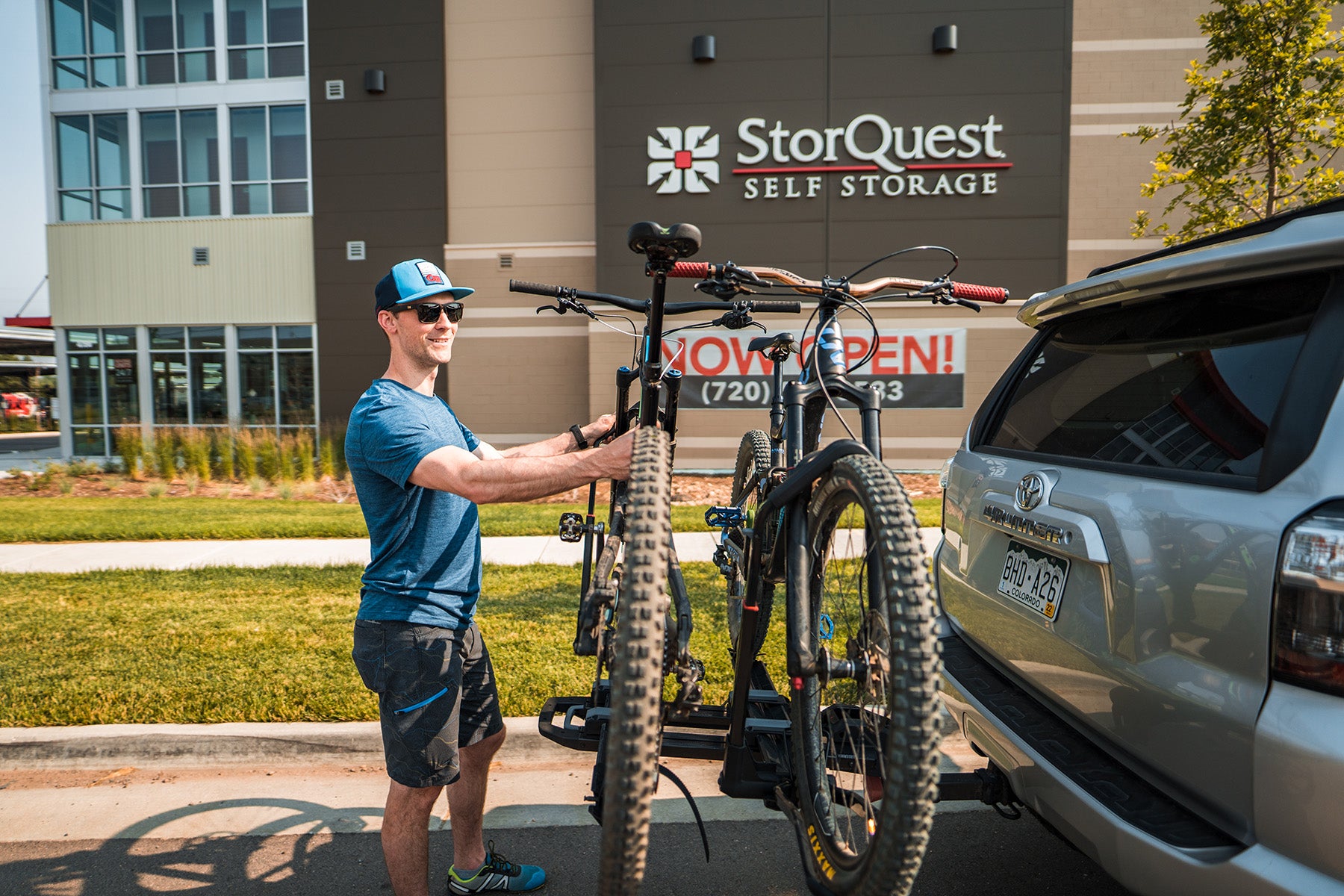 Man loading bikes onto rack (c) StorQuest