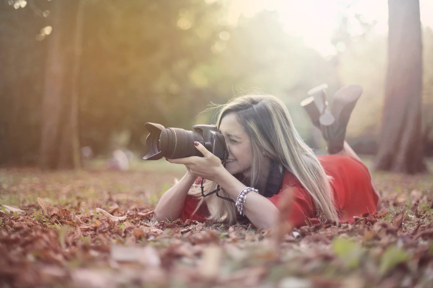 woman holding camera in fall